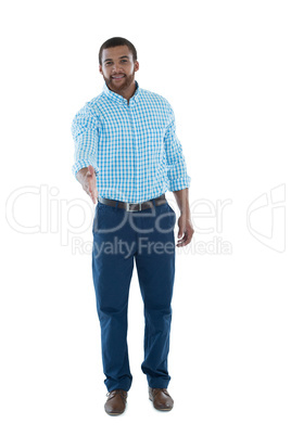 Male executive offering handshake against white background