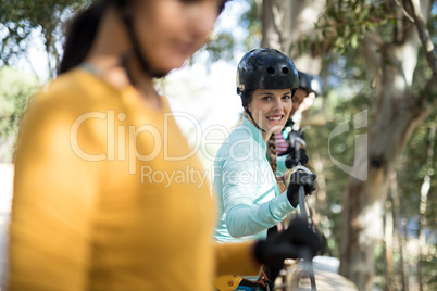 Woman enjoying zip line adventure in park