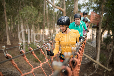 Friends walking on rope bridge