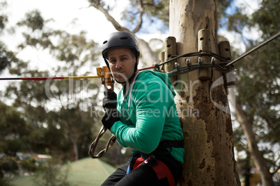 Man ready to zip line in adventure park