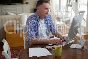 Man working on computer in living room