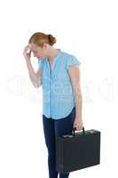 Upset female executive standing with briefcase