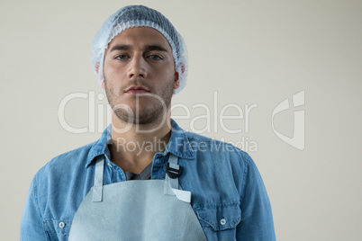 Confident waiter wearing a cap and napkin