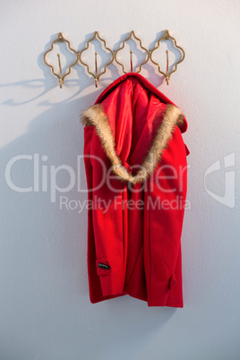 Close-up of red hoodie hanging on hook