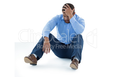 Male executive sitting against white background