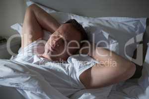 Man sleeping on bed in bedroom