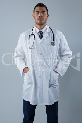 Doctor standing with his hands in pockets