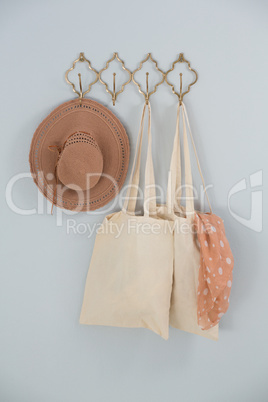 Hat, grocery bag and scarf hanging on hook