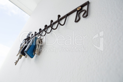 Low angle of various keys hanging on hook