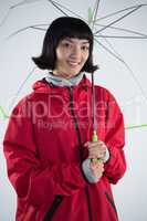 Woman in red jacket holding an umbrella
