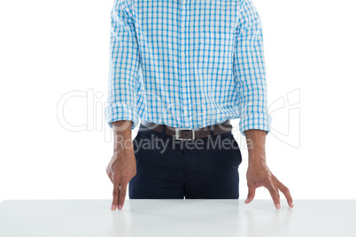 Male executive touching invisible screen on desk