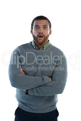 Man standing with arms crossed against white background