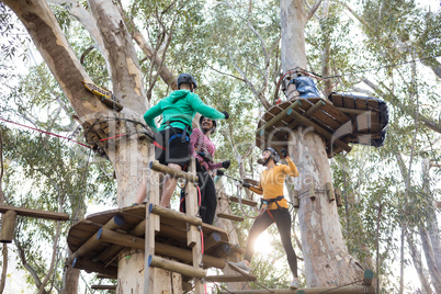 Friends enjoying zip line adventure on vacation