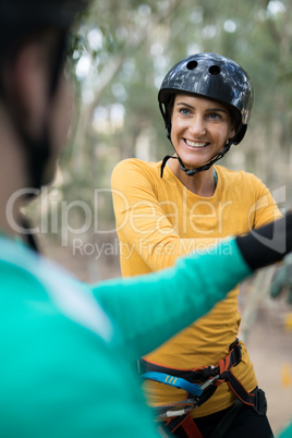 Woman enjoying zip line adventure in park