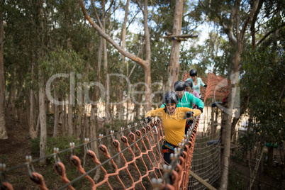 Friends walking on rope bridge