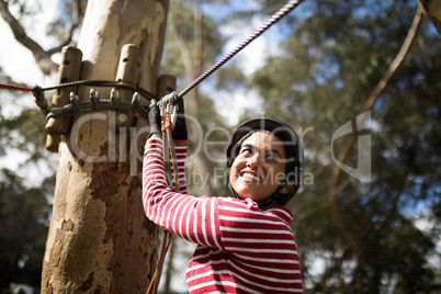 Woman ready to zip line in adventure park