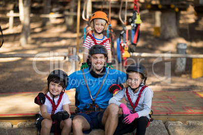 Kids and instructor sitting together in park