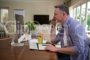 Man talking on mobile phone in living room