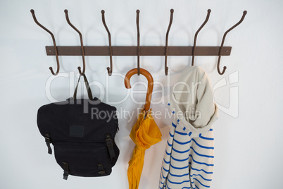 Hoodie, umbrella and bag hanging on hook