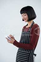 Smiling waitress writing order on notepad