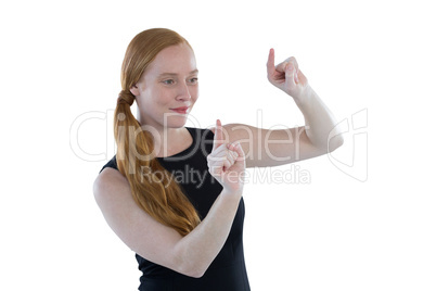 Female executive pretending to use an invisible screen