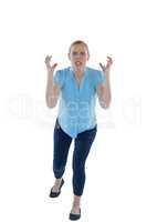 Female executive gesturing against white background