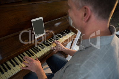 Man playing piano at home