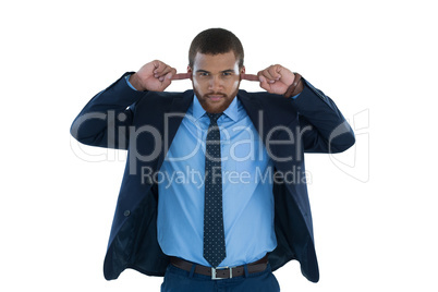 Businessman covering his ears
