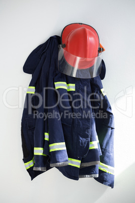 Protective workwear hanging against white wall