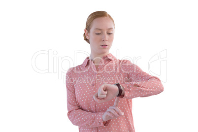 Female executive looking at wristwatch