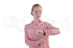 Female executive looking at wristwatch