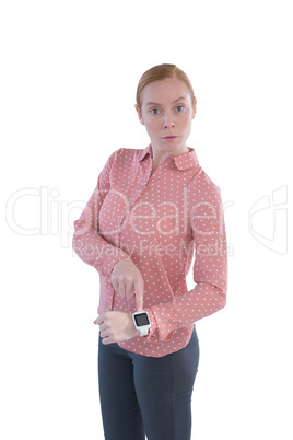 Businesswoman pointing at her smartwatch