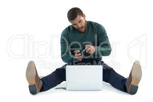 Man playing video game on laptop