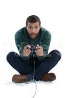 Man playing video game against white background