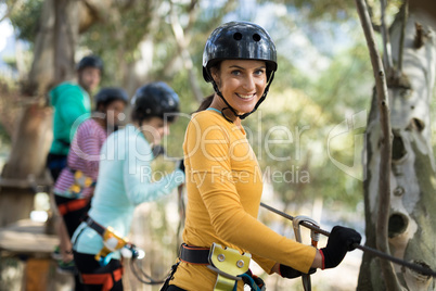 Woman enjoying zip line adventure in park