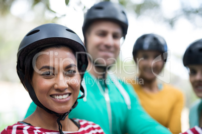 Friends enjoying zip line adventure in park