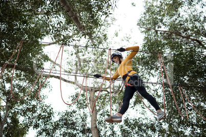 Woman enjoying zip line adventure in park