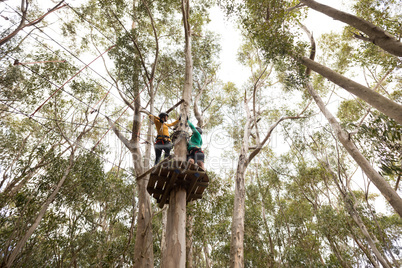 Friends ready to zip line in park