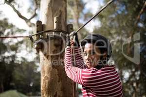 Woman ready to zip line in adventure park