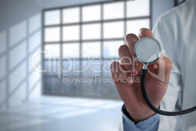 Composite image of mid-section of male doctor using stethoscope