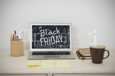 Composite image of laptop and various office accessories on table