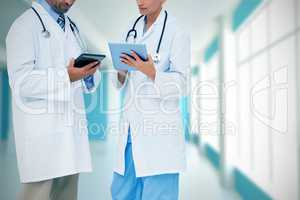 Composite image of doctors discussing something on clipboard