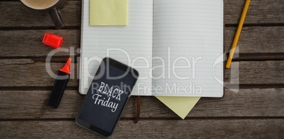 Composite image of organizer, coffee, mobile phone and stationery on wooden plank