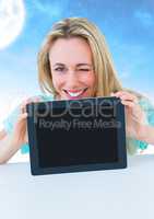 Woman holding tablet with moon background