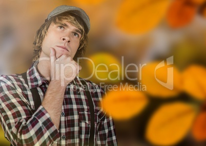 Man thinking in forest with leaves