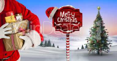 Merry Christmas text and Santa holding gifts with Wooden signpost in Christmas Winter landscape with