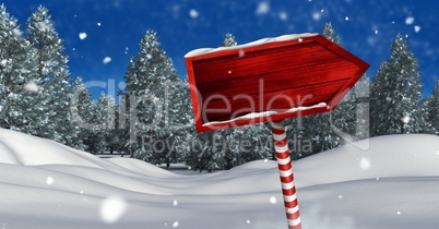 Wooden signpost in Christmas Winter landscape