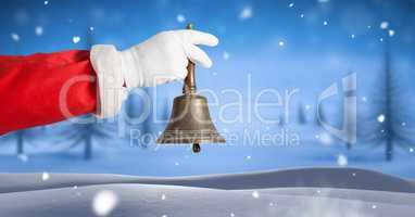 Santa ringing bell in Christmas Winter landscape