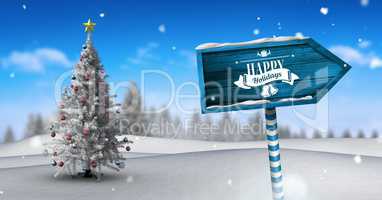 Happy holidays text on Wooden signpost in Christmas Winter landscape with Christmas tree