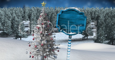 Wooden signpost in Christmas Winter landscape with Christmas tree